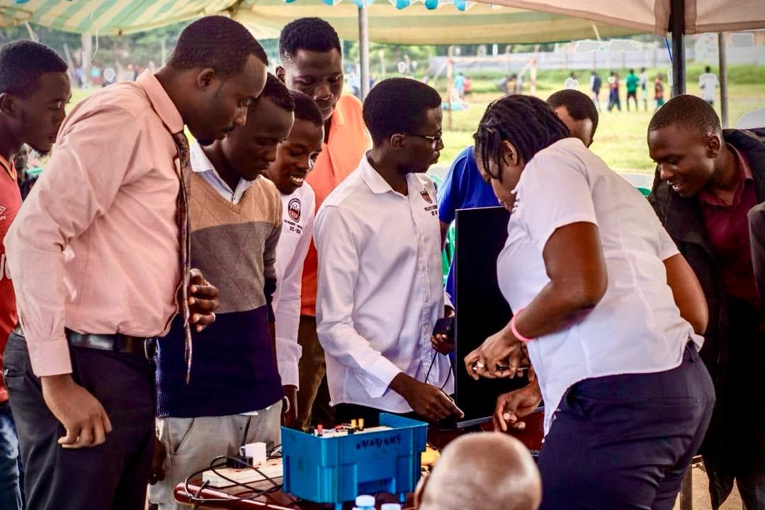 Community members gathered around a hands-on electronics demonstration