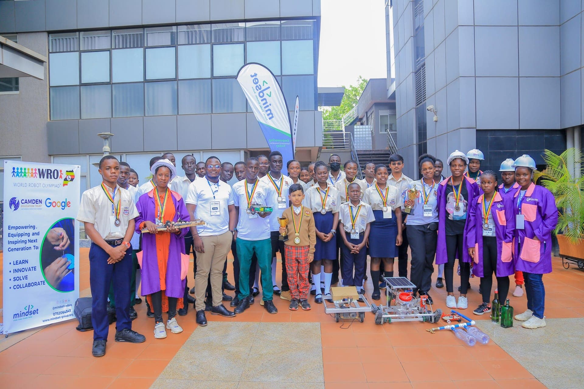 Participants and mentors at an Akili za Kesho robotics championship
