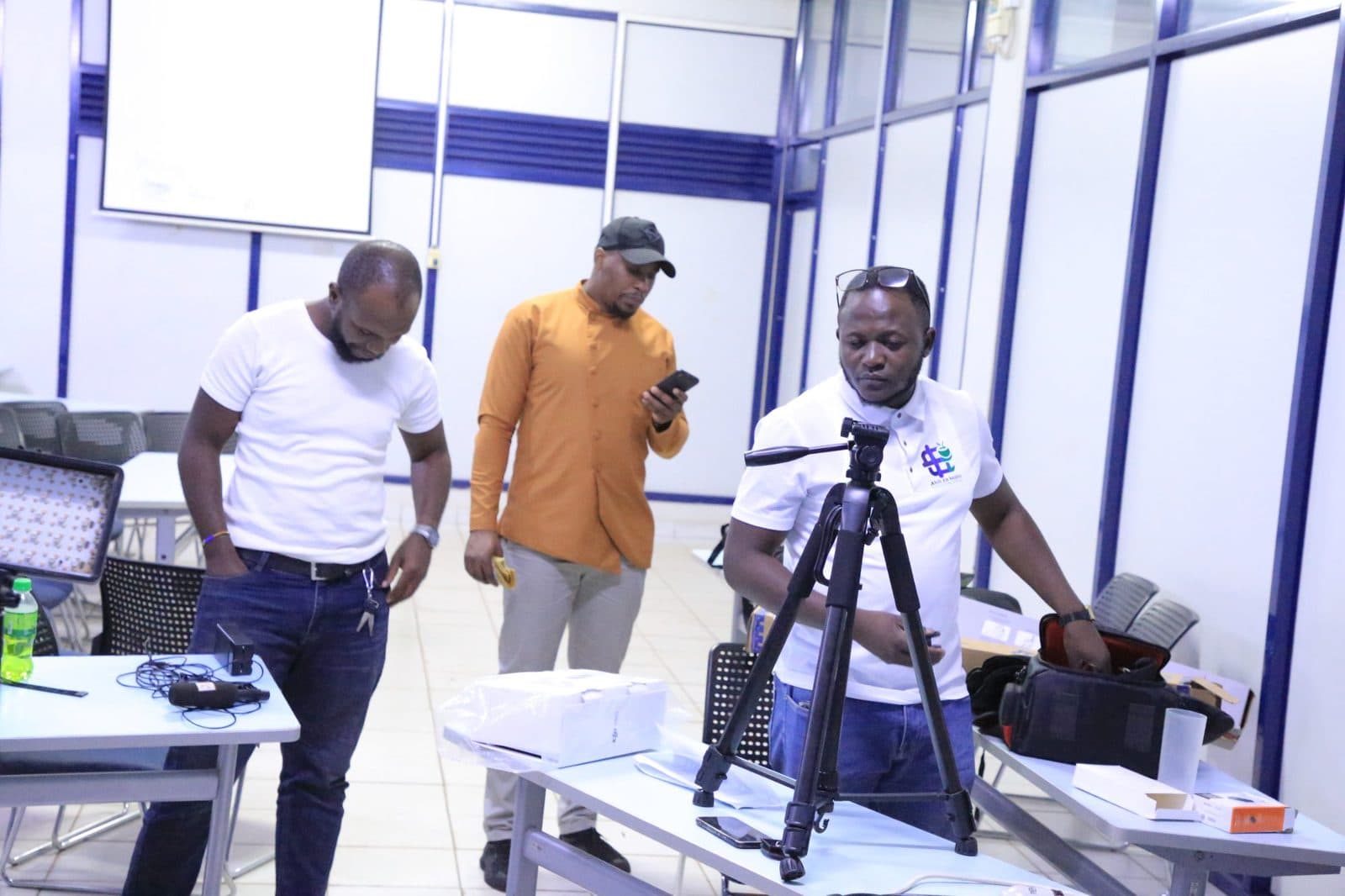 Crew preparing a camera tripod and equipment before recording